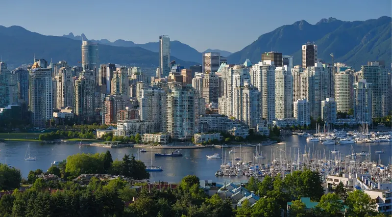 Vancouver downtown skyline and marina backed by Coast Mountains